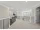 Bright landing area with elegant black railings, providing a view of the staircase and multiple rooms at 6040 Ashborough Park, Cumming, GA 30040
