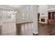 Open-concept living area with stone fireplace, hardwood floors, and large windows at 6040 Ashborough Park, Cumming, GA 30040