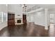 Open-concept living room with fireplace, built-in bookshelves, soaring ceilings, and dark wood floors at 6040 Ashborough Park, Cumming, GA 30040