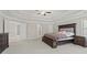 Large main bedroom with tray ceiling, neutral carpet, and two windows at 6040 Ashborough Park, Cumming, GA 30040