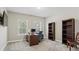 Home office featuring a desk, bookshelves, and natural light, creating a productive workspace at 6040 Ashborough Park, Cumming, GA 30040