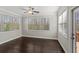 Cozy sunroom with large windows, natural light, and access to a deck, perfect for relaxation at 6040 Ashborough Park, Cumming, GA 30040