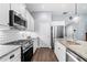 Modern kitchen featuring stainless steel appliances, white cabinetry, granite countertops, and a kitchen island at 107 Grace Cir, Acworth, GA 30102