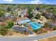 Beautiful aerial view of community featuring clubhouse, pool, tennis courts, basketball court, and mature trees at 12350 Broadleaf Ln, Johns Creek, GA 30005