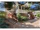 Home's backyard shows wood deck, stairs and mature trees with greenery at 12350 Broadleaf Ln, Johns Creek, GA 30005