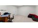 Finished basement area features neutral carpet and white walls with desk and comfortable seating at 12350 Broadleaf Ln, Johns Creek, GA 30005