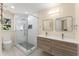 Modern bathroom with double vanity, glass shower, and neutral finishes at 12350 Broadleaf Ln, Johns Creek, GA 30005