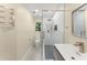 Bright bathroom features a glass enclosed shower, modern fixtures, and a heated towel rack at 12350 Broadleaf Ln, Johns Creek, GA 30005