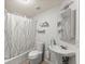 Small bathroom with white fixtures and shower at 12350 Broadleaf Ln, Johns Creek, GA 30005