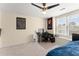 Neutral bedroom features a ceiling fan, natural light, and a dedicated desk area at 12350 Broadleaf Ln, Johns Creek, GA 30005