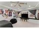 Stylish bedroom featuring a ceiling fan and large windows, creating a comfortable and inviting space at 12350 Broadleaf Ln, Johns Creek, GA 30005