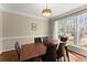 Dining room featuring hardwood floors, modern lighting, and ample natural light at 12350 Broadleaf Ln, Johns Creek, GA 30005