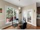 Dining room with a glass table, four chairs, and lots of natural light at 12350 Broadleaf Ln, Johns Creek, GA 30005