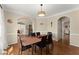 Dining room featuring hardwood floors, decorative lighting, and ample natural light at 12350 Broadleaf Ln, Johns Creek, GA 30005