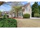 Well-maintained home with manicured lawn, mature landscaping, and stone facade accents at 12350 Broadleaf Ln, Johns Creek, GA 30005