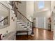 Elegant foyer with hardwood floors, grand staircase, and decorative iron railings at 12350 Broadleaf Ln, Johns Creek, GA 30005