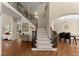 Spacious foyer featuring hardwood floors, staircase, and elegant architectural details at 12350 Broadleaf Ln, Johns Creek, GA 30005