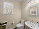Neat half bath includes a wide vanity and a large mirror in a neutral color palette at 12350 Broadleaf Ln, Johns Creek, GA 30005