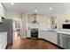 Modern kitchen with stainless steel appliances, white cabinetry, and open layout at 12350 Broadleaf Ln, Johns Creek, GA 30005