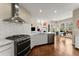 Modern kitchen with stainless steel appliances, white cabinetry, and open layout at 12350 Broadleaf Ln, Johns Creek, GA 30005