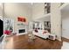 Bright living room features a fireplace, large windows, and hardwood floors at 12350 Broadleaf Ln, Johns Creek, GA 30005