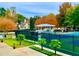 Community tennis courts and pavilion are surrounded by beautiful trees in autumn colors at 12350 Broadleaf Ln, Johns Creek, GA 30005