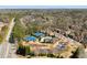 Aerial view of the community featuring tennis courts, swimming pool, and clubhouse surrounded by mature trees at 4183 Hill House Sw Rd, Smyrna, GA 30082