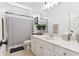 This bathroom offers a spacious vanity, a large mirror, and a shower with marble-like tiles at 4183 Hill House Sw Rd, Smyrna, GA 30082