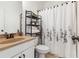 Bathroom with a single sink vanity, neutral color palette, and shower-tub combo at 4183 Hill House Sw Rd, Smyrna, GA 30082