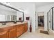 Bathroom boasts double vanity, framed mirror, shower, and access to walk-in closet at 4183 Hill House Sw Rd, Smyrna, GA 30082