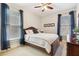 Cozy bedroom with a queen-size bed, ceiling fan, and natural light at 4183 Hill House Sw Rd, Smyrna, GA 30082