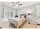 Well-lit bedroom featuring a plush bed, neutral walls, and natural light from a window with shutters, a simple and calming space at 4183 Hill House Sw Rd, Smyrna, GA 30082