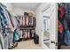 Walk-in closet with clothes racks and shoe storage leading to bathroom at 4183 Hill House Sw Rd, Smyrna, GA 30082