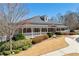 Inviting home with a covered porch and manicured landscaping, creating a warm and welcoming atmosphere at 4183 Hill House Sw Rd, Smyrna, GA 30082