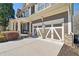 Attached two-car garage with modern doors and a spacious driveway, offering convenient parking at 4183 Hill House Sw Rd, Smyrna, GA 30082