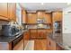 Kitchen with stainless appliances, granite countertops, tile backsplash, and wood cabinetry at 4183 Hill House Sw Rd, Smyrna, GA 30082