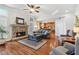 Inviting living room with stone fireplace, hardwood floors, and a view into the kitchen at 4183 Hill House Sw Rd, Smyrna, GA 30082