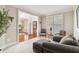 Cozy living room with bright windows, comfortable seating, and open doorway to the dining room at 4183 Hill House Sw Rd, Smyrna, GA 30082