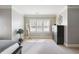 Bright main bedroom with natural light, shutters, carpet flooring, and a dark wood dresser at 4183 Hill House Sw Rd, Smyrna, GA 30082