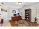 This home office features a large wooden desk, a stately bookcase, and natural light from the window overlooking the yard at 4183 Hill House Sw Rd, Smyrna, GA 30082