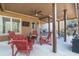 Relaxing covered patio with wood furniture and ceiling fan at 4183 Hill House Sw Rd, Smyrna, GA 30082