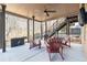 Covered patio area with comfortable Adirondack chairs and outdoor ceiling fan at 4183 Hill House Sw Rd, Smyrna, GA 30082