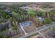 Sprawling property featuring a light blue house, long driveway, and lots of surrounding mature trees at 5761 Dixie Hwy, Rutledge, GA 30663