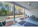 Covered back porch with backyard view, ceiling fan and outdoor dining furniture at 5761 Dixie Hwy, Rutledge, GA 30663