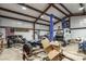 Large metal garage workshop with an oversized lift and overhead lighting at 5761 Dixie Hwy, Rutledge, GA 30663