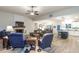 Bright living room with fireplace, hardwood floors, ceiling fan, and open view to the kitchen at 5761 Dixie Hwy, Rutledge, GA 30663
