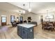 Open floor plan showcases kitchen island, living room with fireplace and dining area at 5761 Dixie Hwy, Rutledge, GA 30663