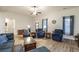 Open-concept living room with cozy seating and lots of natural light at 5761 Dixie Hwy, Rutledge, GA 30663