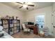 A cozy office with shelving units, a computer desk, and a ceiling fan at 5761 Dixie Hwy, Rutledge, GA 30663