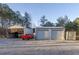 Multiple outbuildings including garages, a covered tractor and RV parking area at 5761 Dixie Hwy, Rutledge, GA 30663